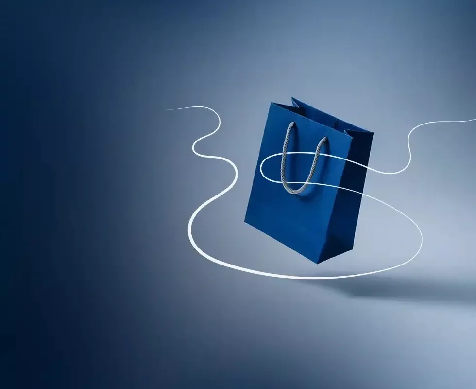 Bolsa azul sobre fondo neutro, representando ventas y comercio.